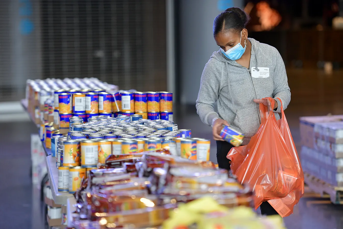 A volunteer packs bags for emergency food distribution during the COVID-19 pandemic