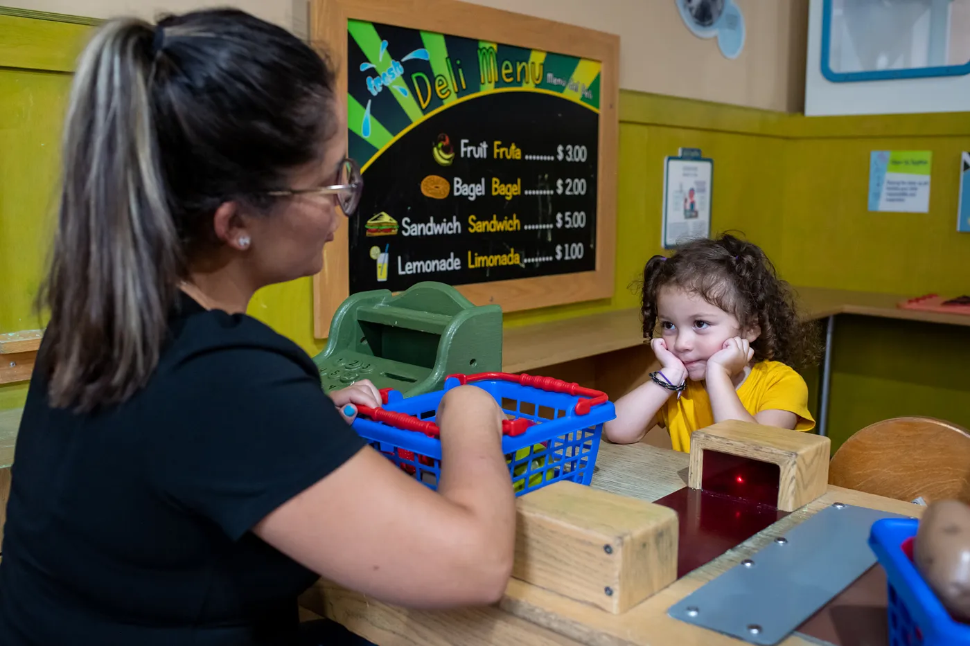 A child playing in daycare with her teacher