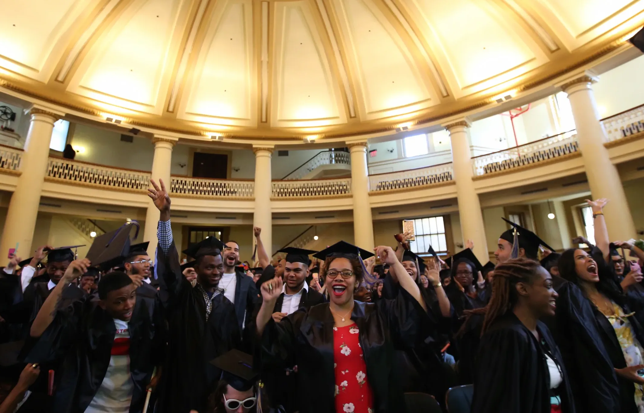 College students celebrating at a graduation ceremony.
