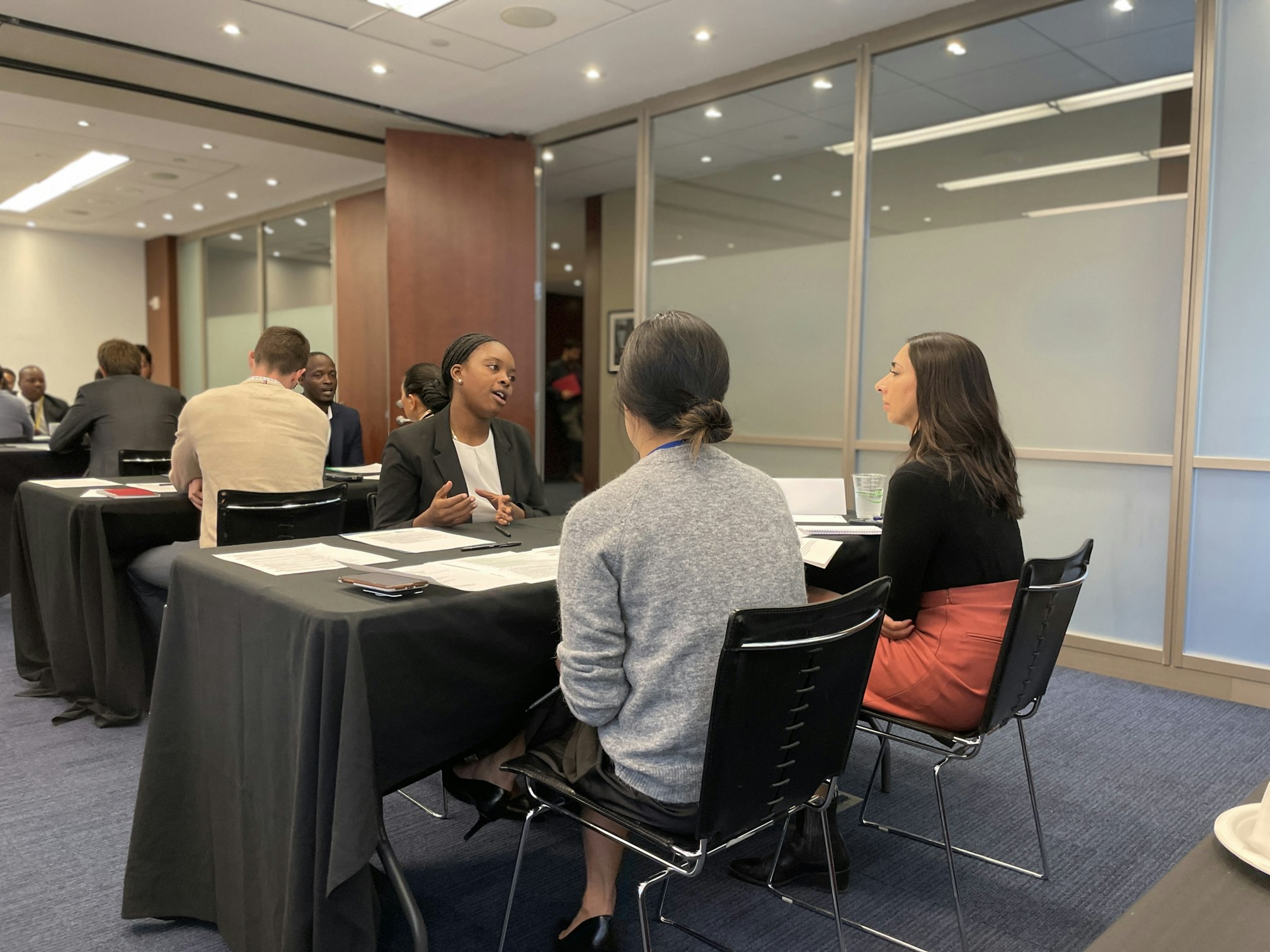 Three people participating in a mock interview.