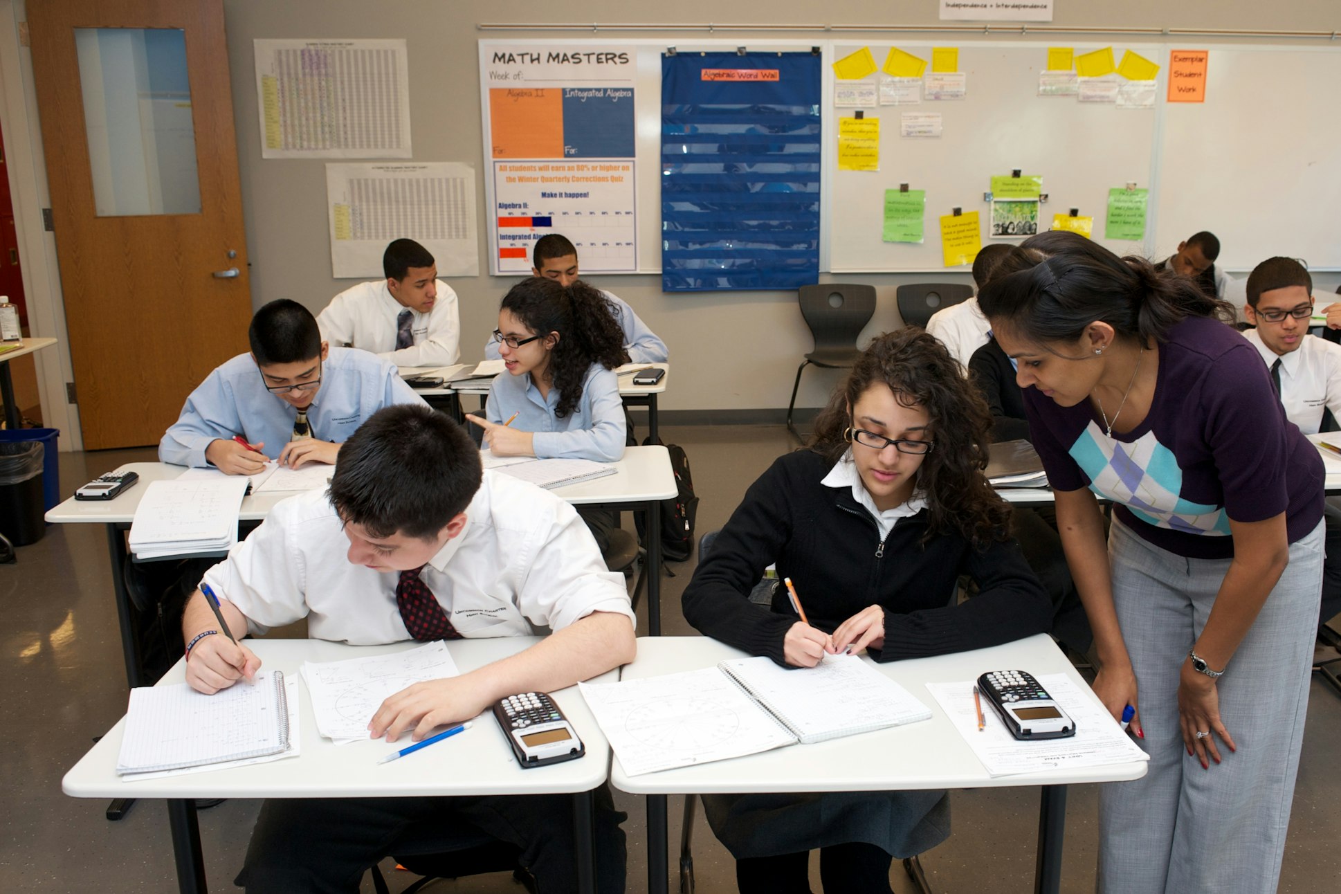 A teacher instructing two students at a school in Crown Heights, Brooklyn.