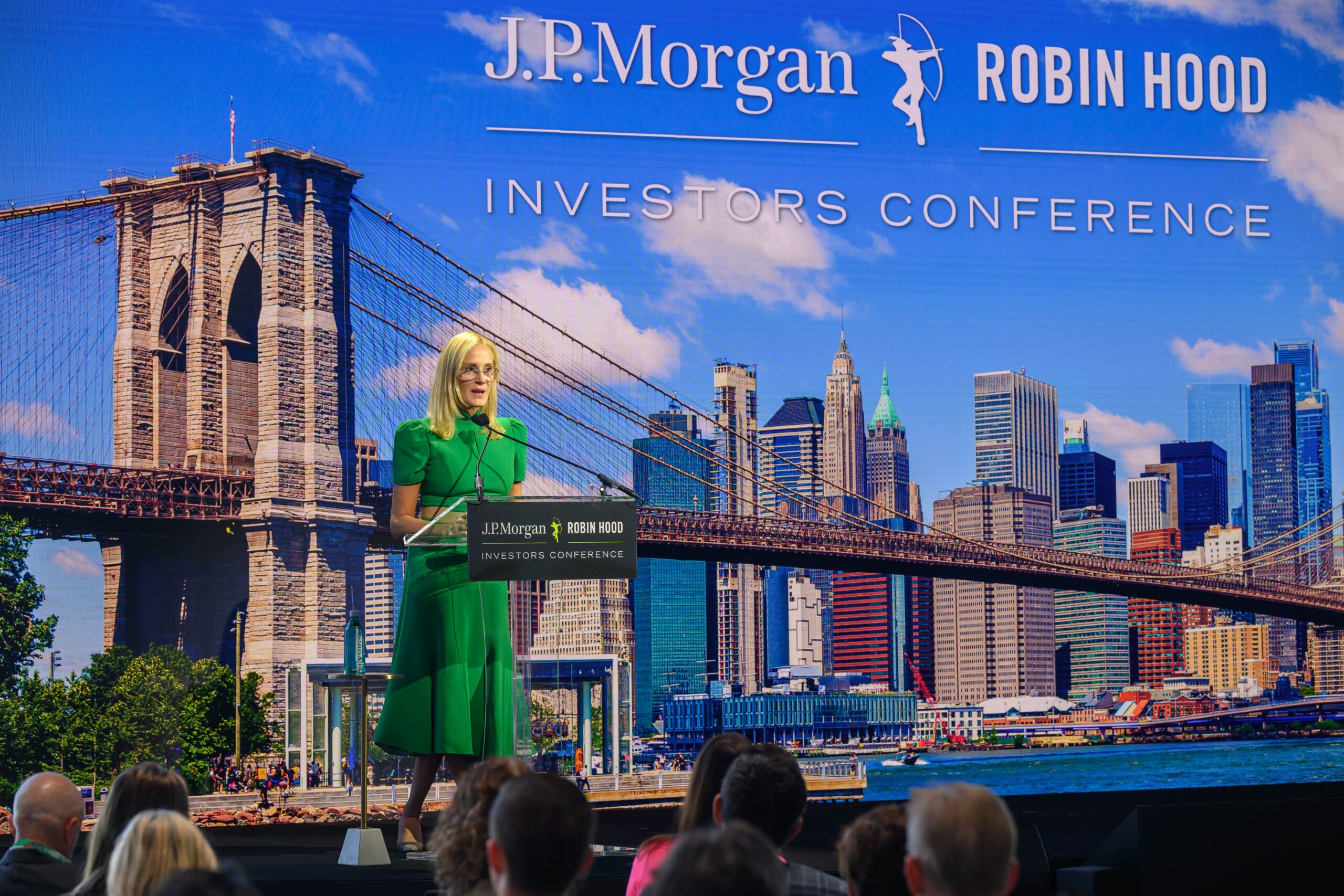 Kristin Lemkau speaking to an audience from a podium at Robin Hood's Investors Conference.